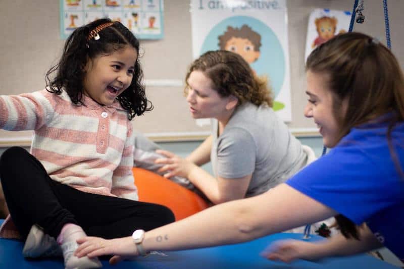 adults helping child